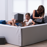 children playing with foam blocks on a foam pit in a room.