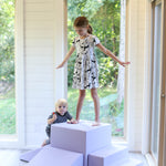 A girl standing on a foamnasium lavender gymnasium