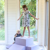 A girl standing on a foamnasium lavender gymnasium