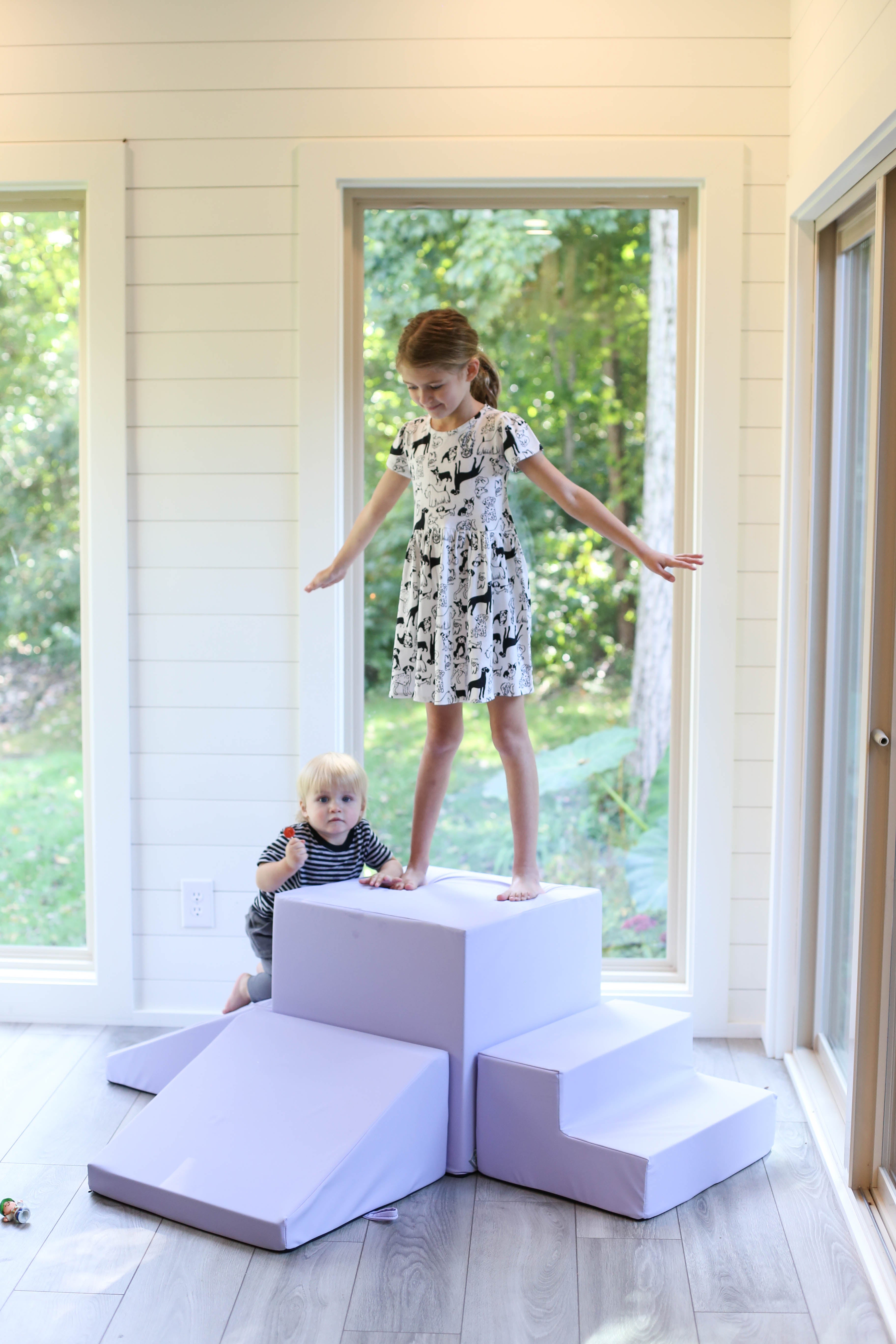 A girl standing on a foamnasium lavender gymnasium