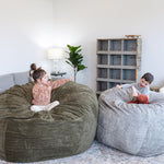 Two children playing in Haven bean bags in a cozy living room.