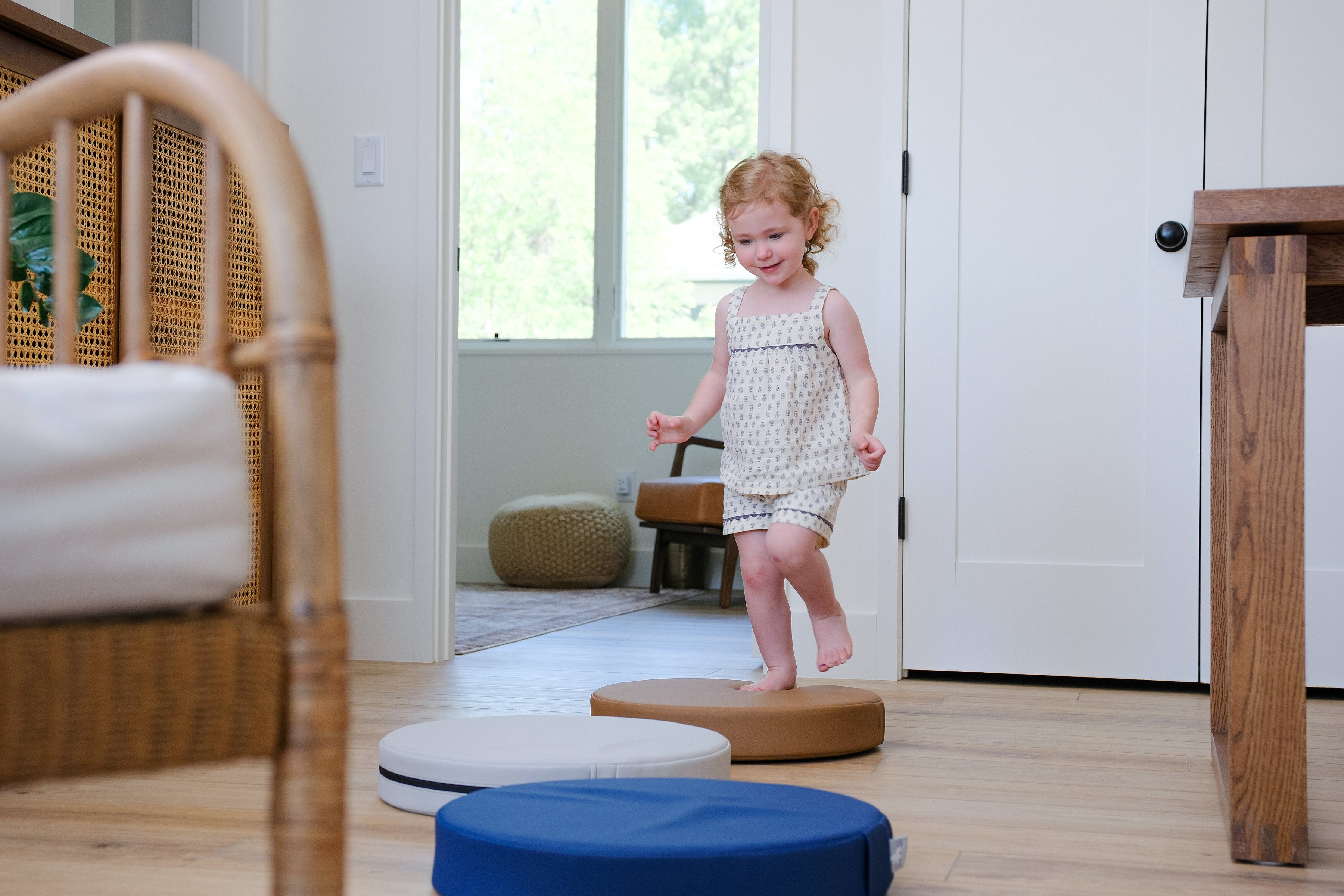 Lifestyle photo of girl playing with Ink, Auster, and Nutmeg Roundabouts by Foamnasium.