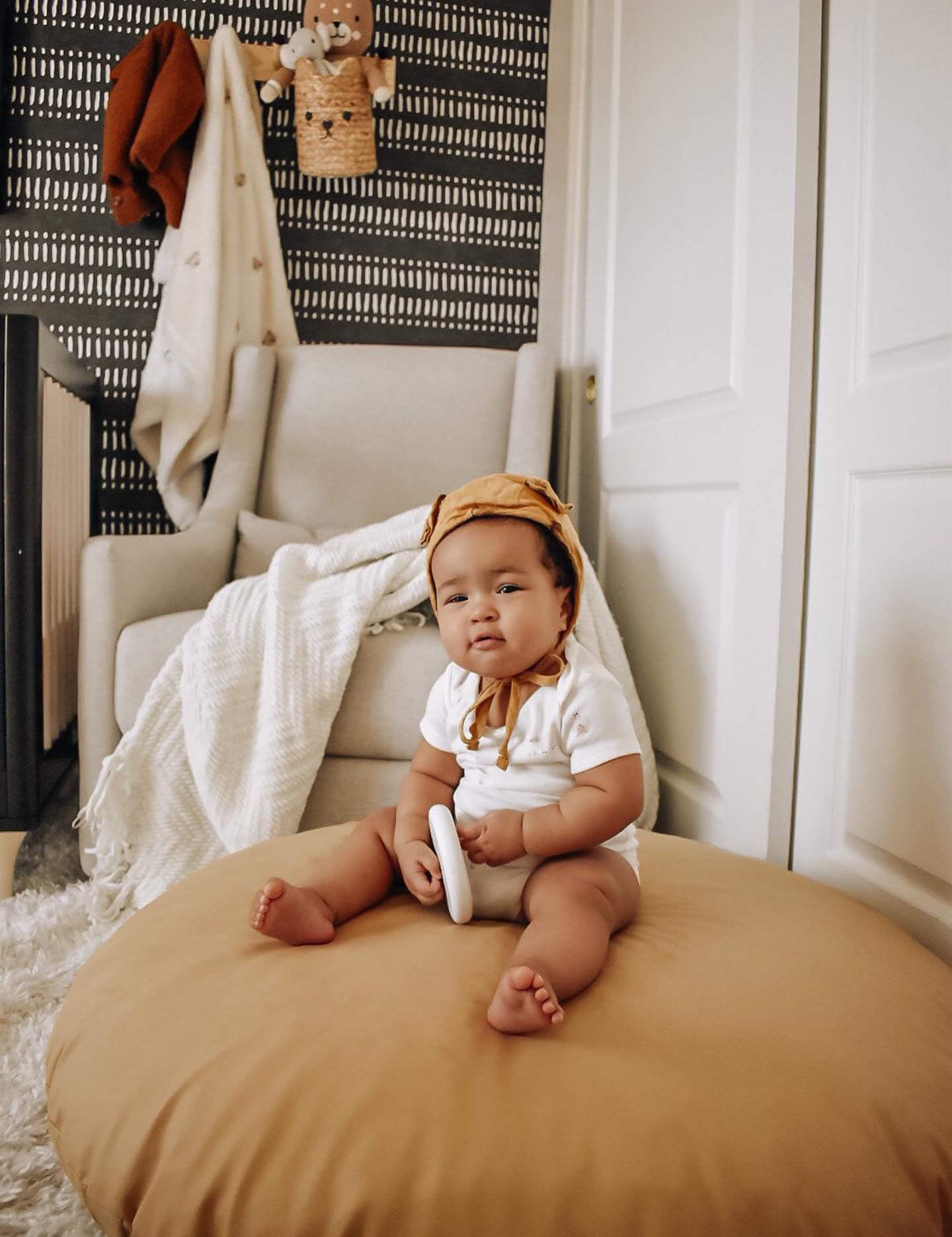 LIfestlye image of a baby sitting on a camel spot