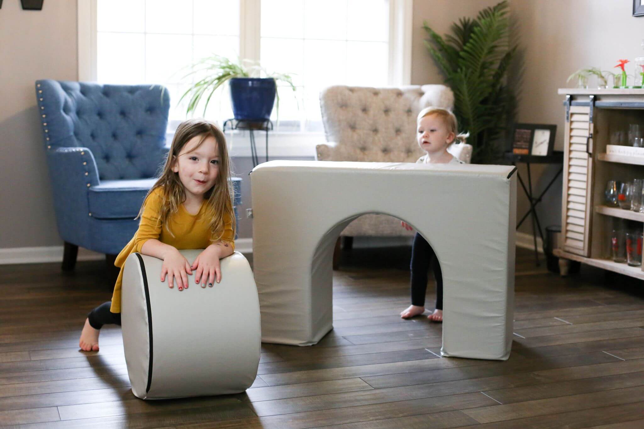 Lifestyle photo of two girls playing with a Gull Gray Foamnasium Arch.