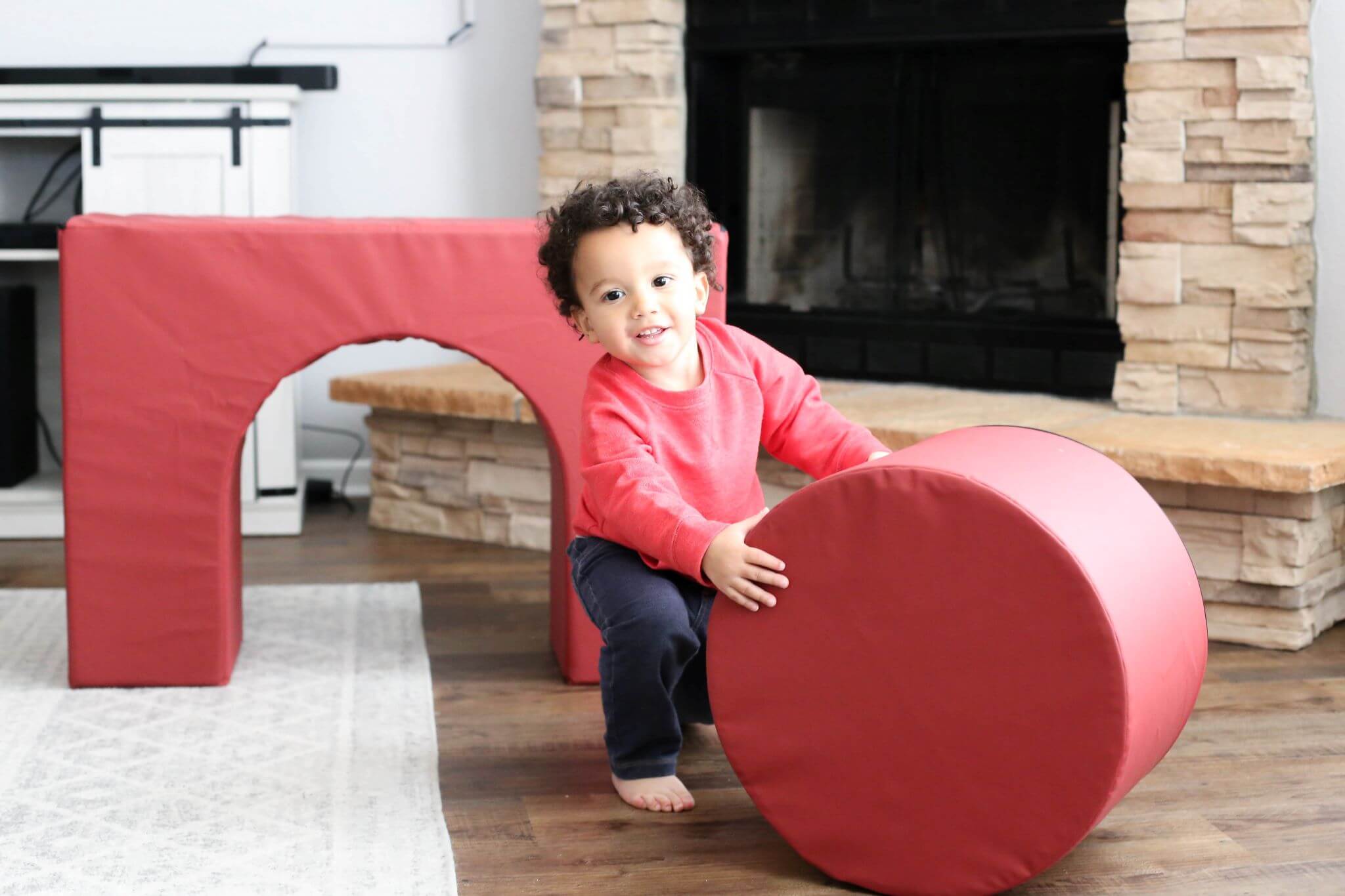 Lifestyle photo of a boy playing on Enhanced Crimson Foamnasium Arch