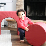 Lifestyle photo of a boy playing on Enhanced Crimson Foamnasium Arch