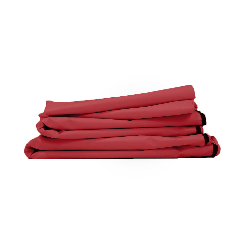 Stack of folded light blue-gray fabric items with black end details, likely curtains or bedding