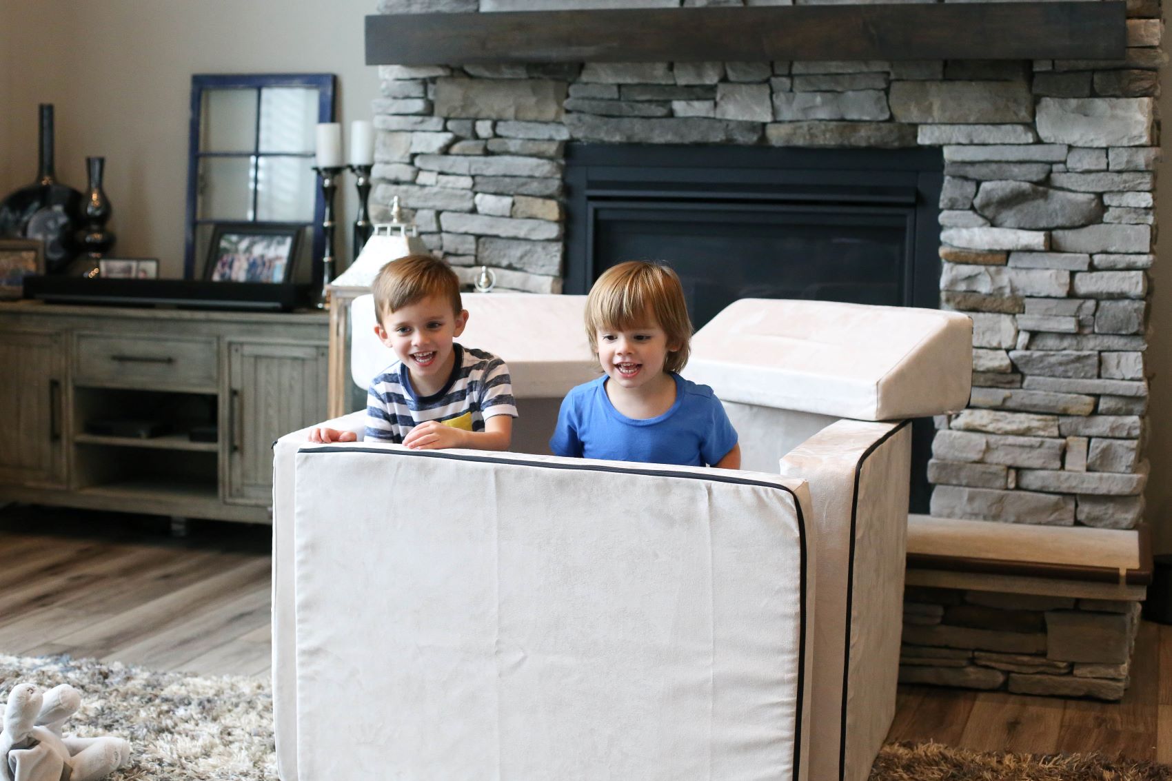 Lifestyle photo of two boys playing with a Cement color Blocksy by Foamnasium and Pottery Barn