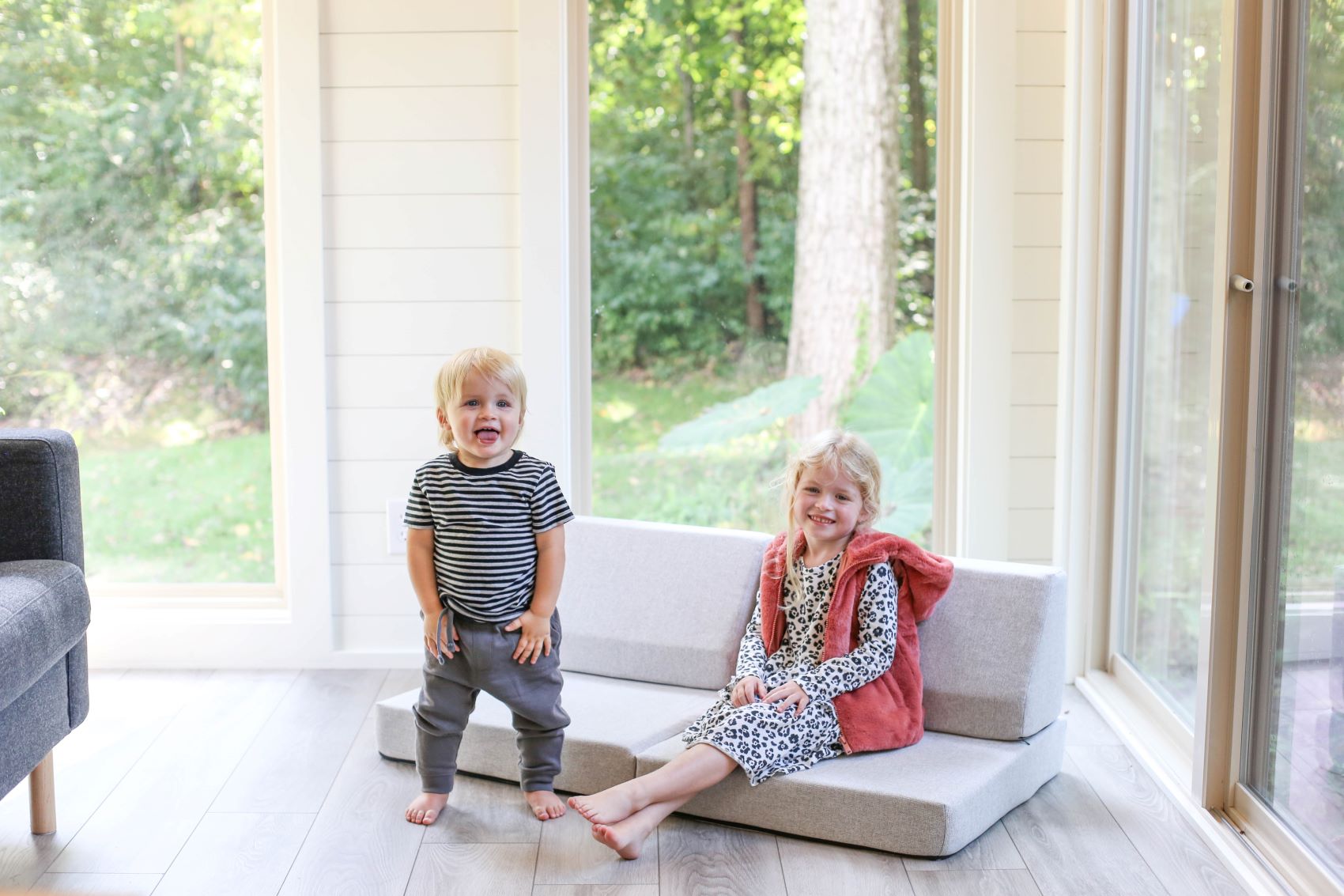 Lifestyle image of two children playing and sitting on a Basketweave Dove Gray Blocksy Mini by Foamnasium and Pottery Barn Kids