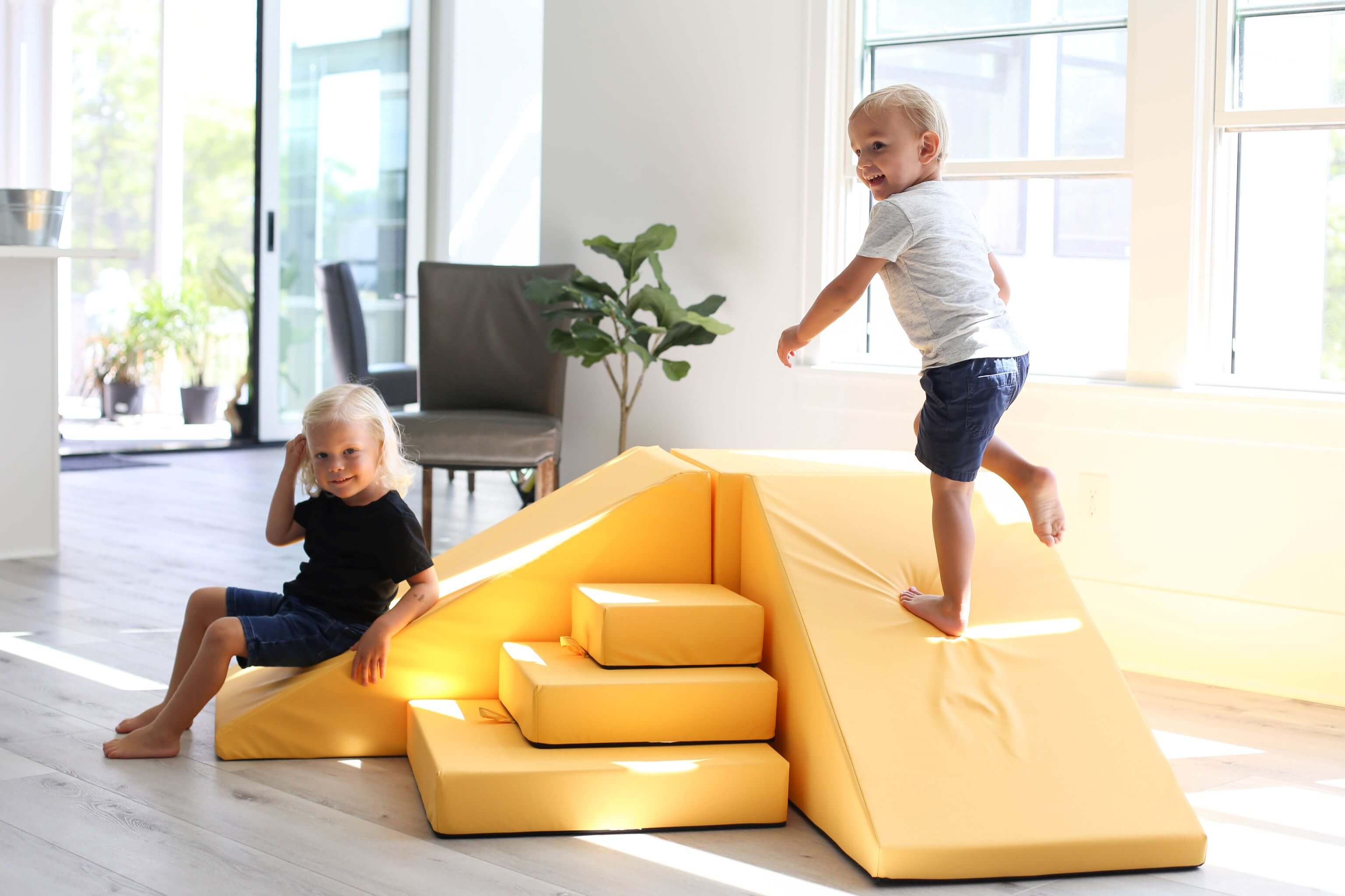 Lifestyle Photo of two boys playing on an Enhanced Marigold Foamnasium Corner Climber Set