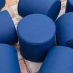 Pile of Navy Foamnasium Cylinders on a rug in a living room
