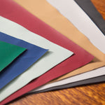 Color swatches of various colors on a wooden surface