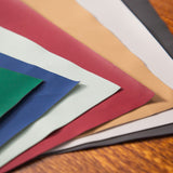 Color swatches of various colors on a wooden surface