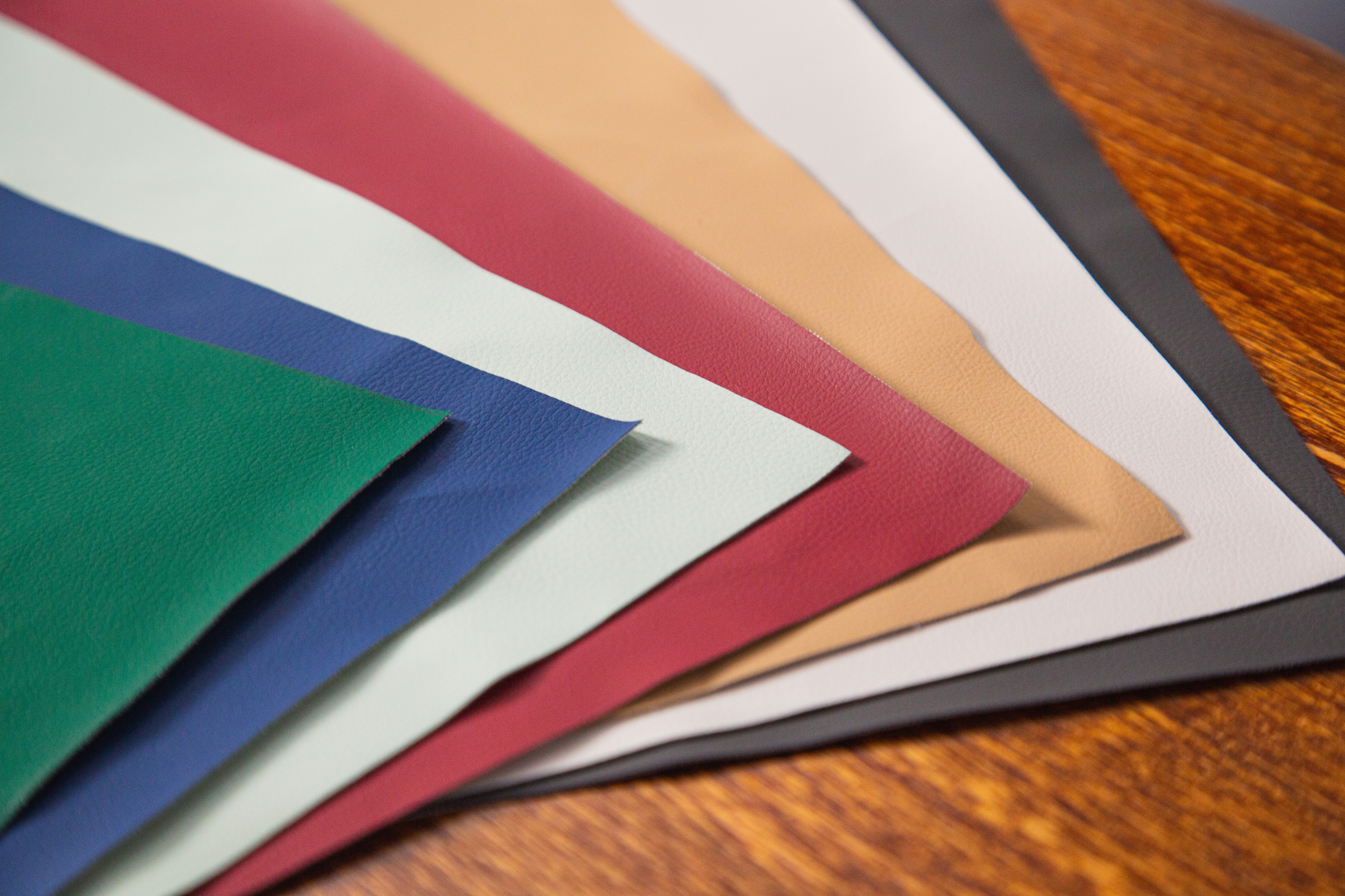 Color swatches of various colors on a wooden surface