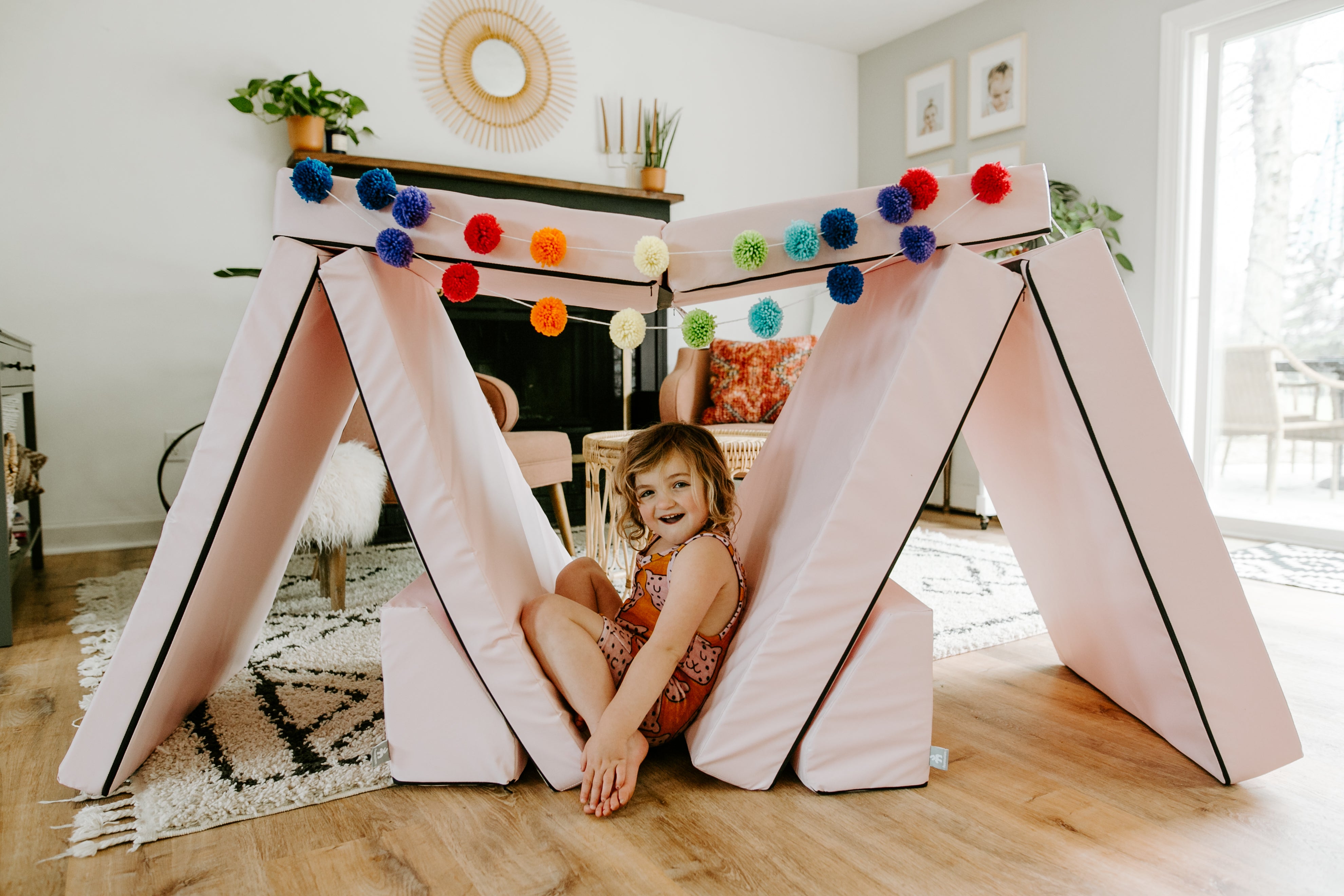 Lifestyle photo of a girl sitting under a Pink Foamnasium Blocksy