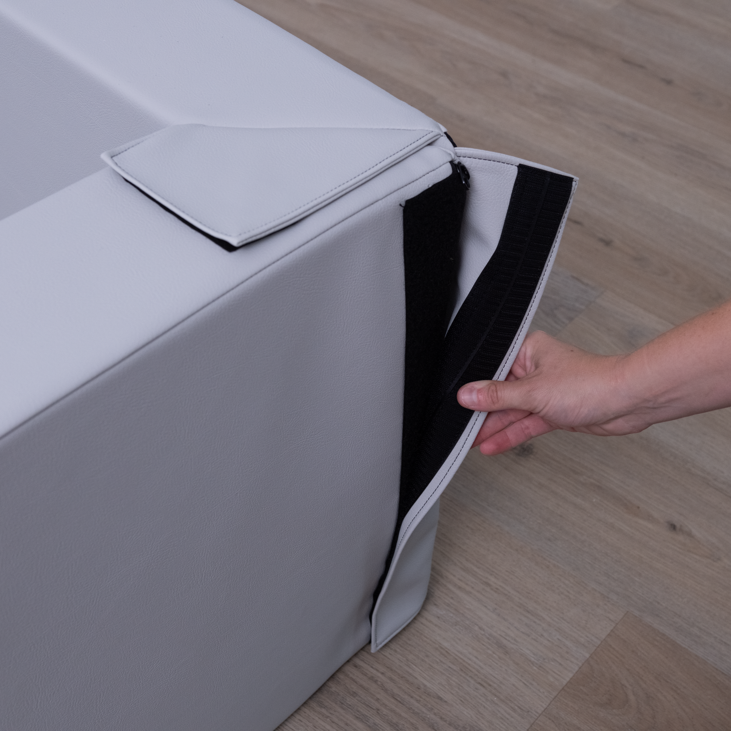 Demonstrating how to velcro the two sides of a foam pit together