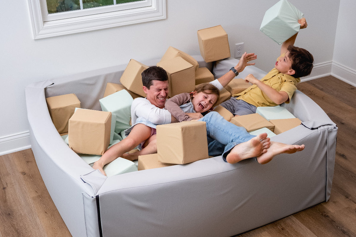 Dad playing with kids in Foamnasium foam pit 