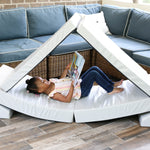 A lifestyle photo of a girl sitting in a blocksy reading