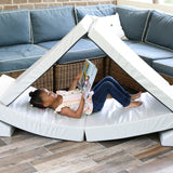 A lifestyle photo of a girl sitting in a blocksy reading