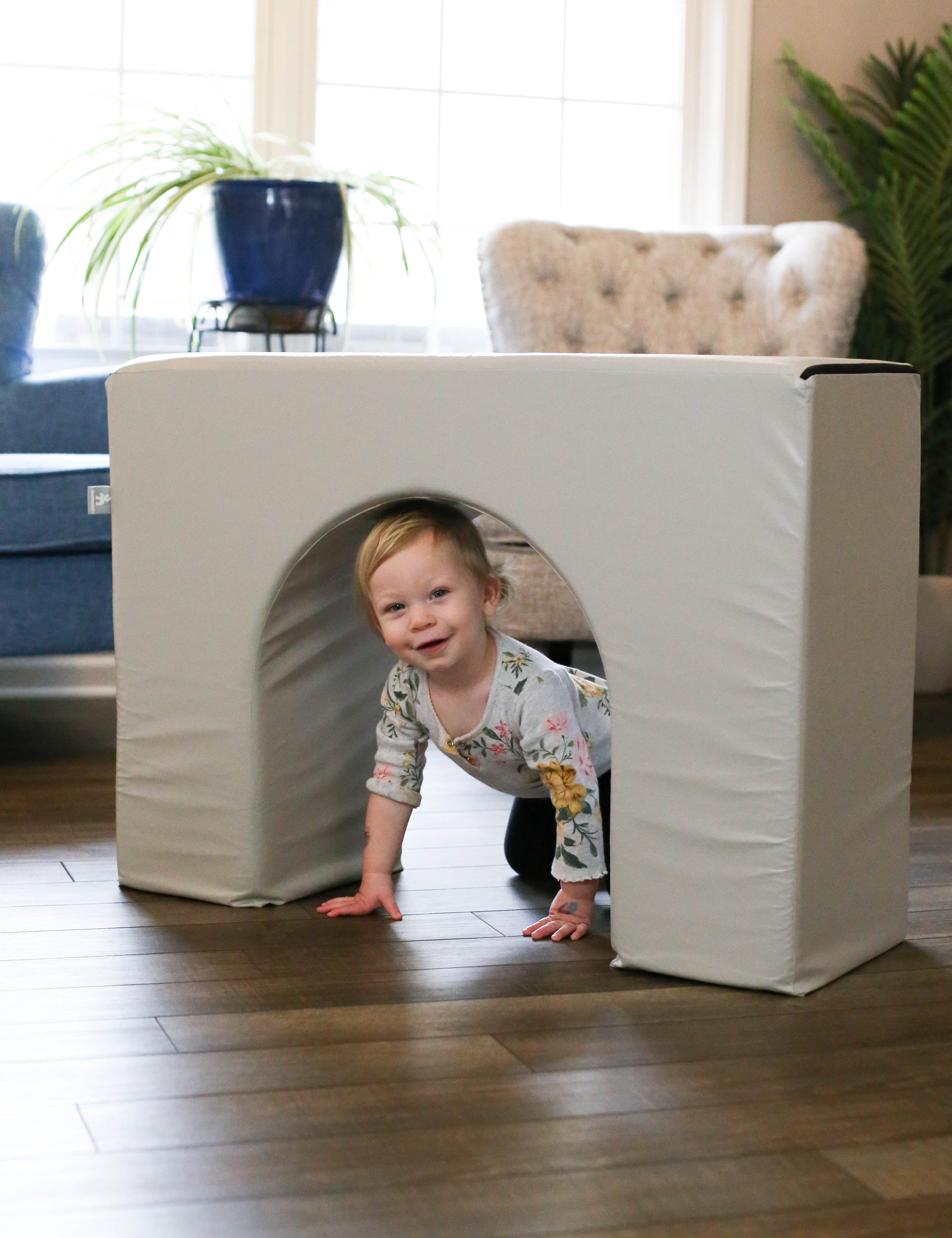 Lifestyle photo of a girl playing with a Gull Gray Foamnasium Arch.