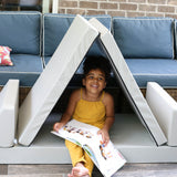 A photo of a girl sitting in a Gull Gray Blocksy set up as a tent