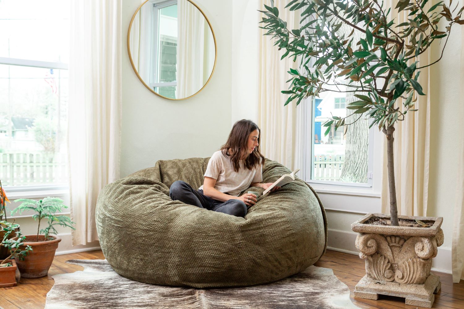 Lifestyle photo of a woman reading a book while sitting in a large Sage Haven by Comfort Option