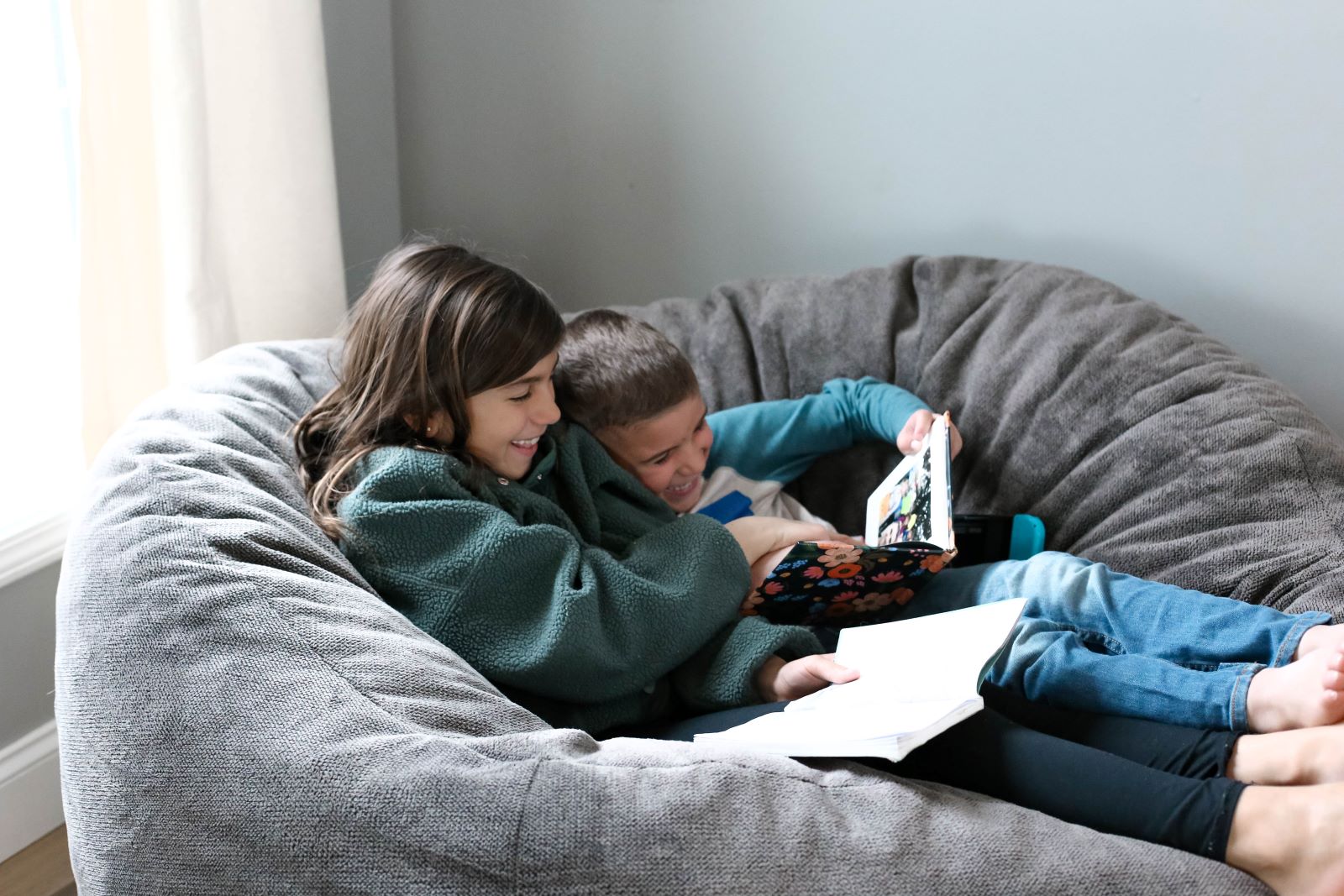 Photo of two kids reading while sitting in a Large Fleece Iron Haven by Comfort Option