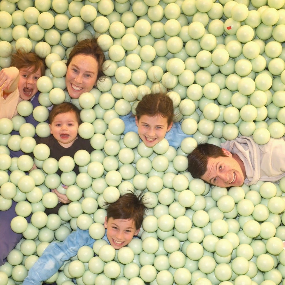 Photo of a family playing in a ball pit