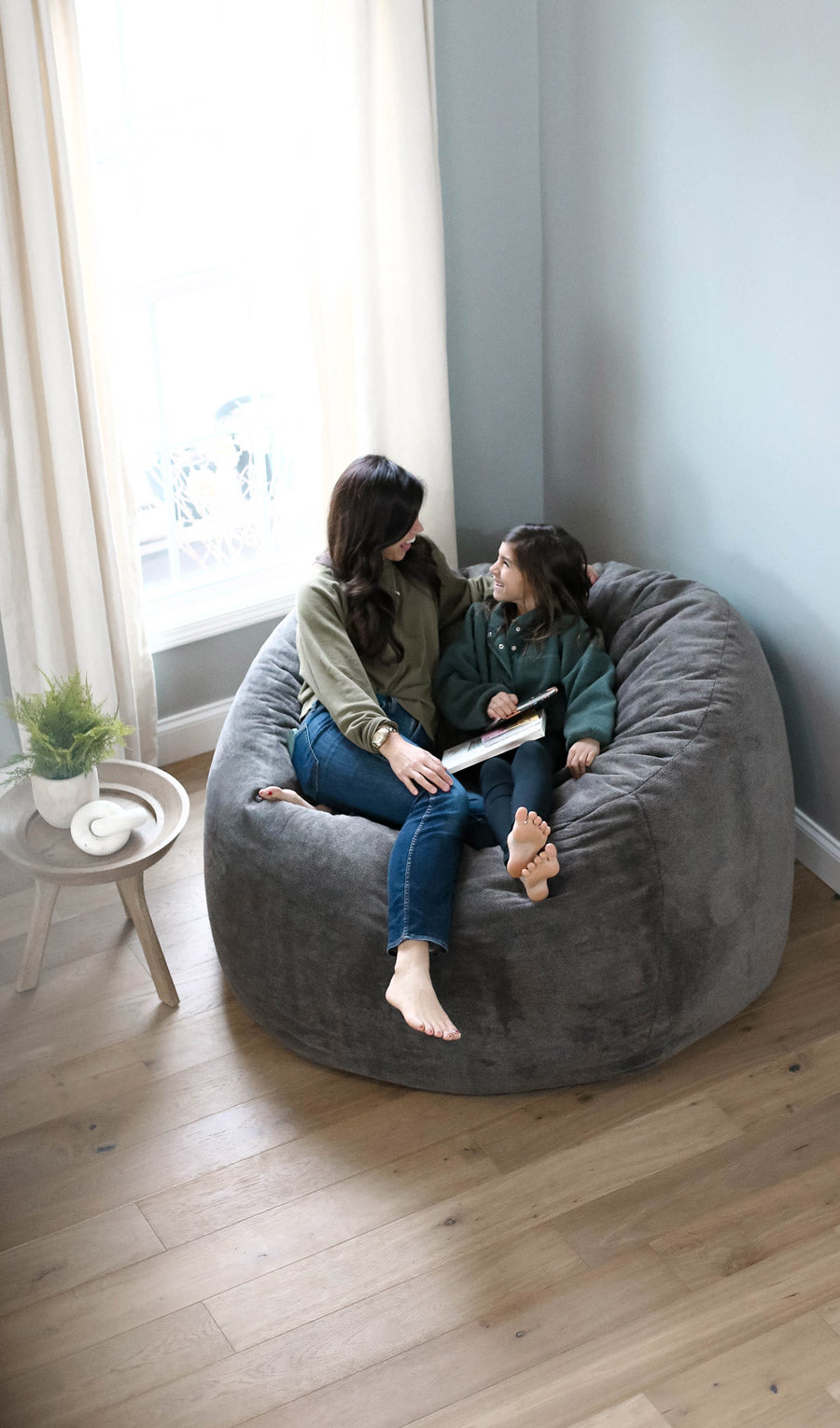 A woman and girl sitting in a large haven in Fleece Iron by Comfort Option