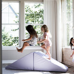 Lifestyle photo of three girls playing on an Enhanced Lavender Foamnasium Mega Wedges Set