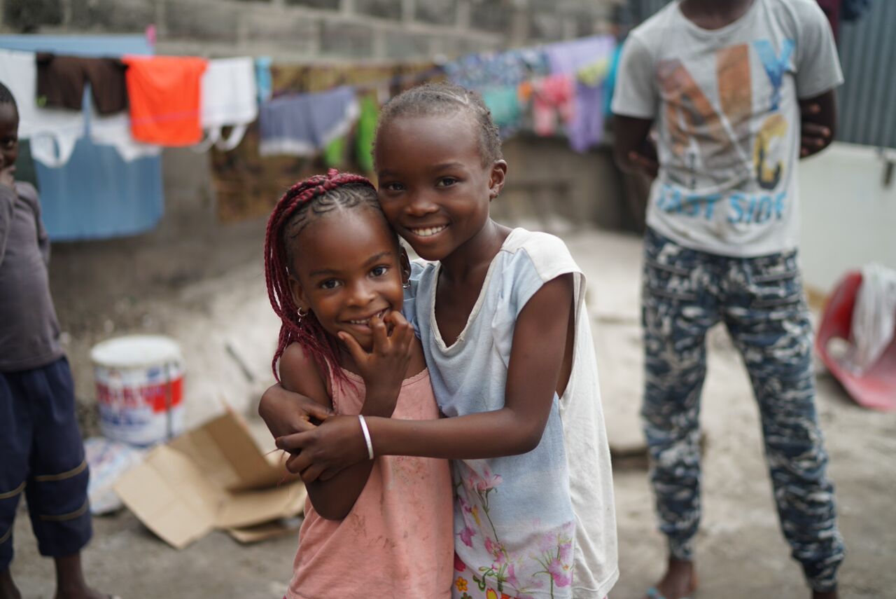 Photo of two children standing on a street at Mwana Villages