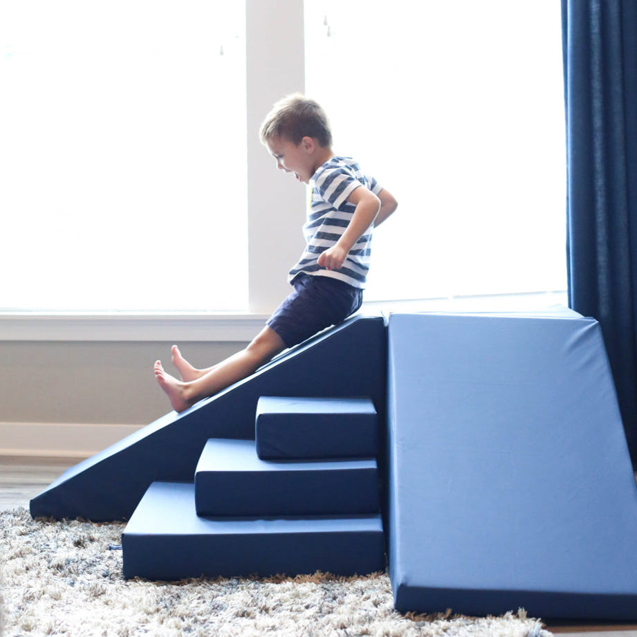 Boy sliding on Foamnasium Corner Climber in Navy