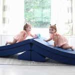 Two girls climbing over a Foamnasium Navy Blocksy