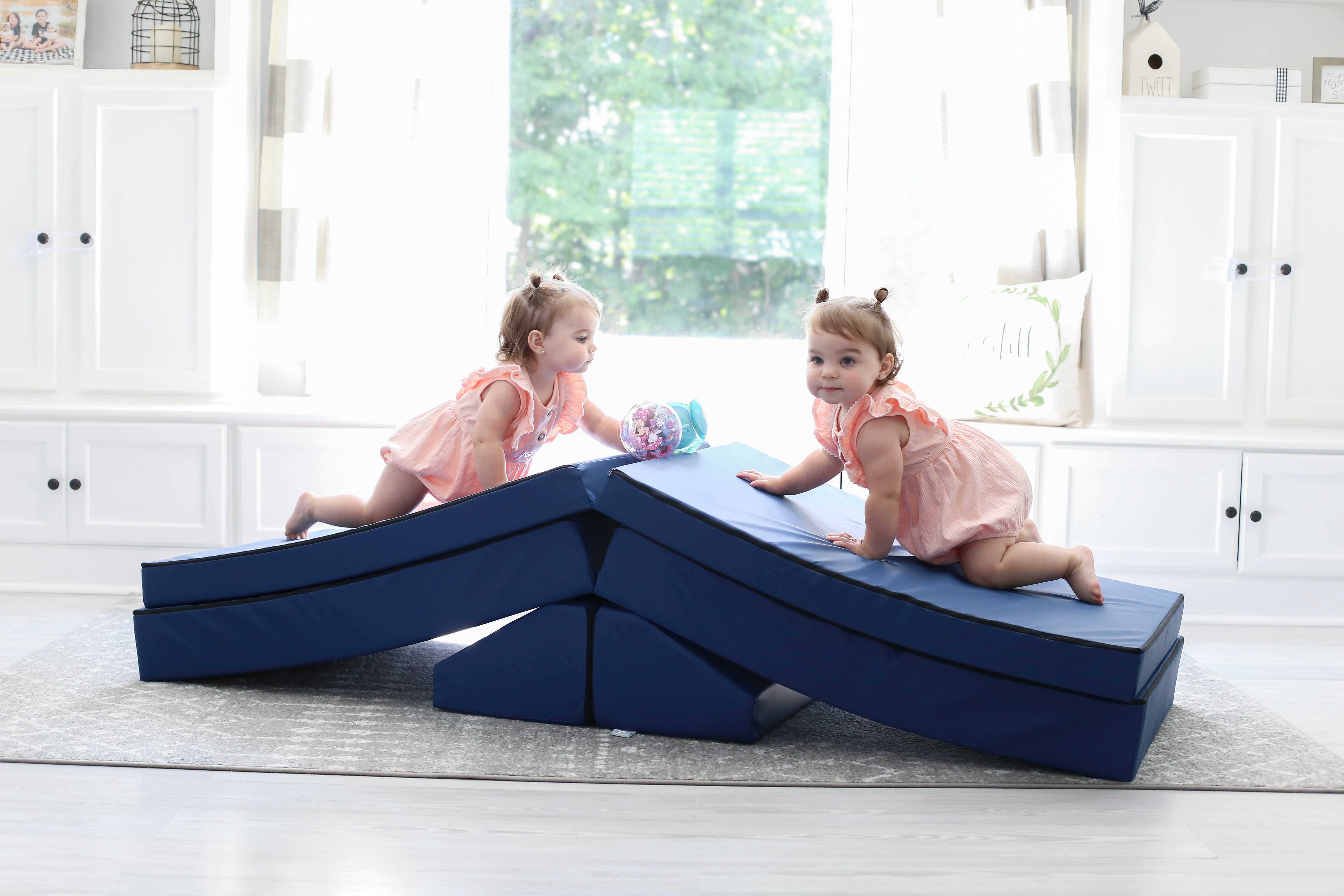 Two girls climbing over a Foamnasium Navy Blocksy