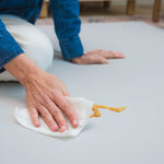 Person cleaning a surface with a cloth