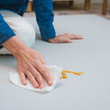 Person cleaning a surface with a cloth