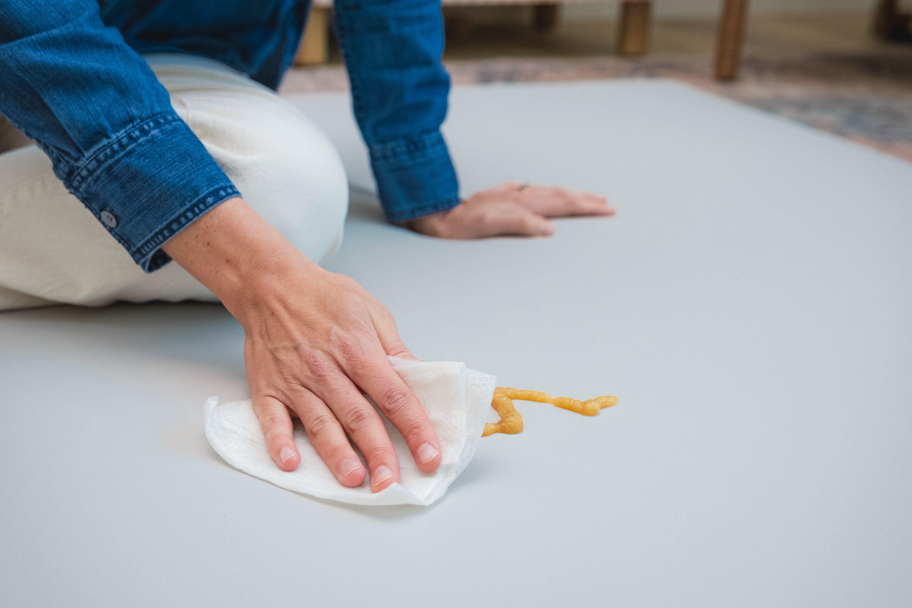 Person cleaning a surface with a cloth