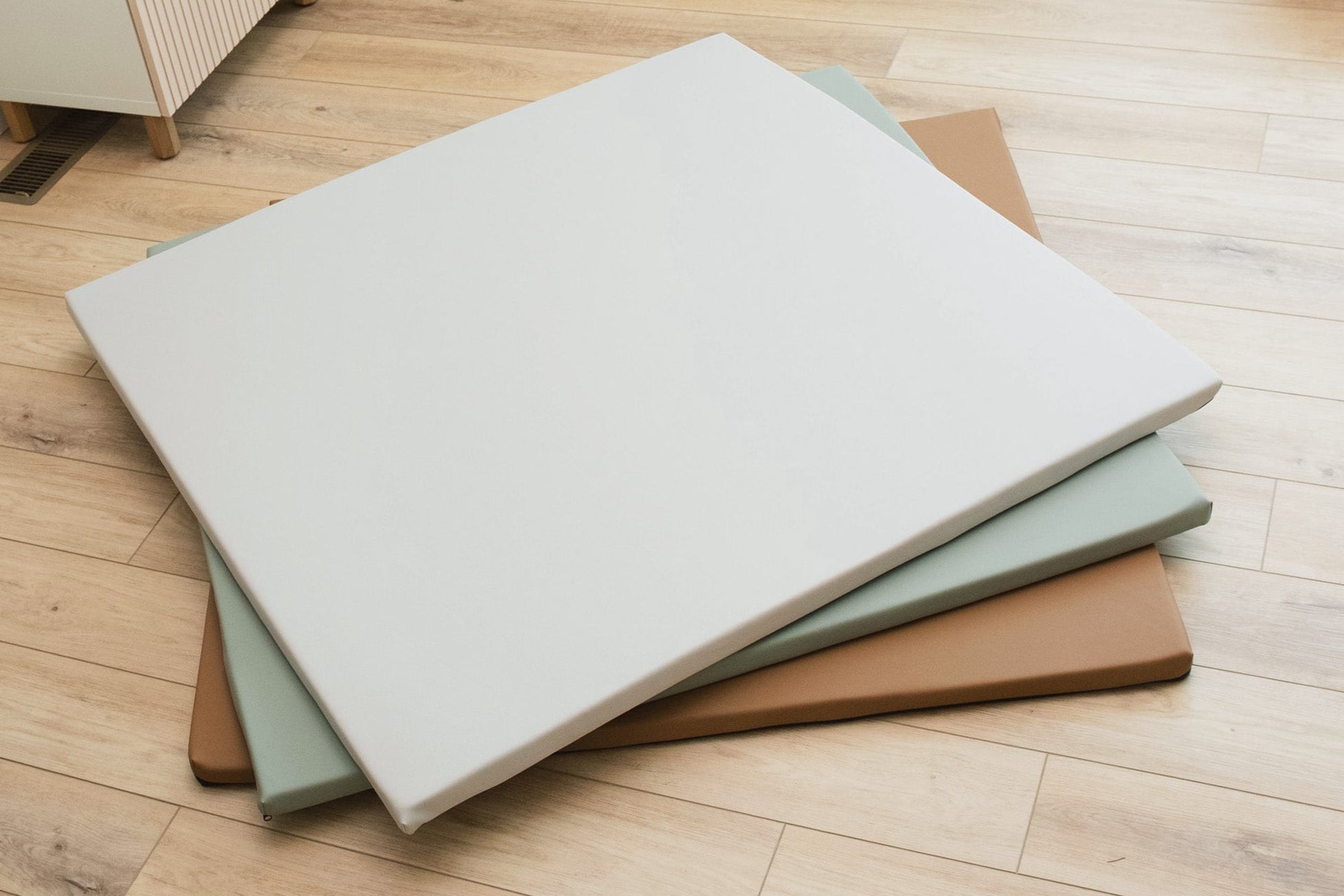 Stack of foam pads on a wooden floor