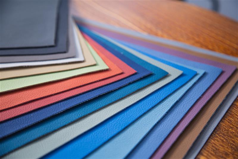 Color swatches of leather in various colors on a wooden surface