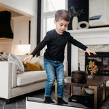 Lifestyle Photo of a boy balancing on an Enhanced Snow Foamnasium Mini Tumbler