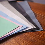 Colorful paper sheets on a wooden surface