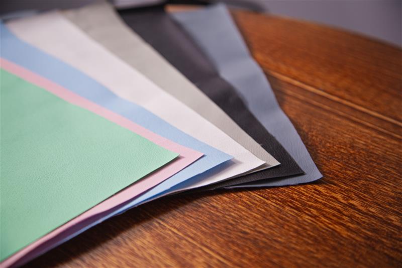 Colorful paper sheets on a wooden surface