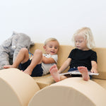 Lifestyle photo of two children reading on an Enhanced Camel Foamnasium Blocksy +